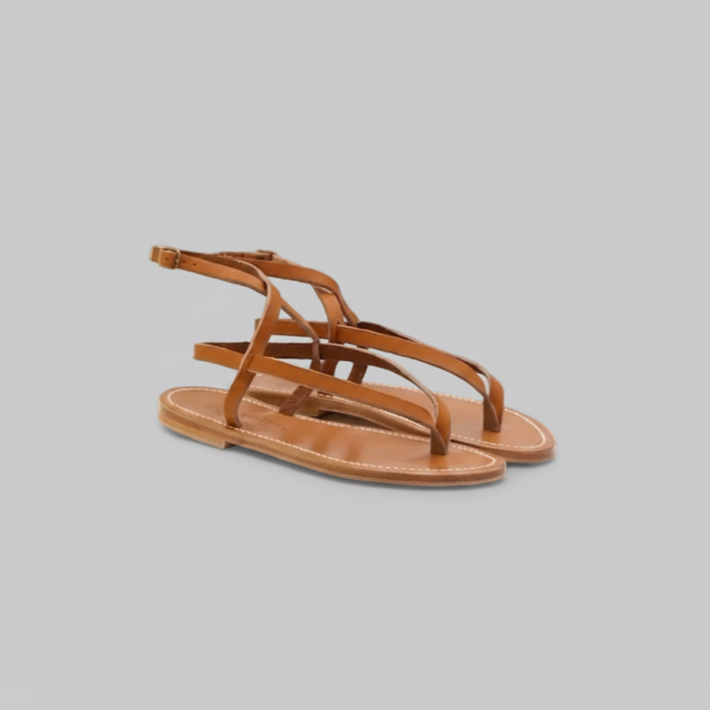 Brown sandal with multiple straps on a gray background