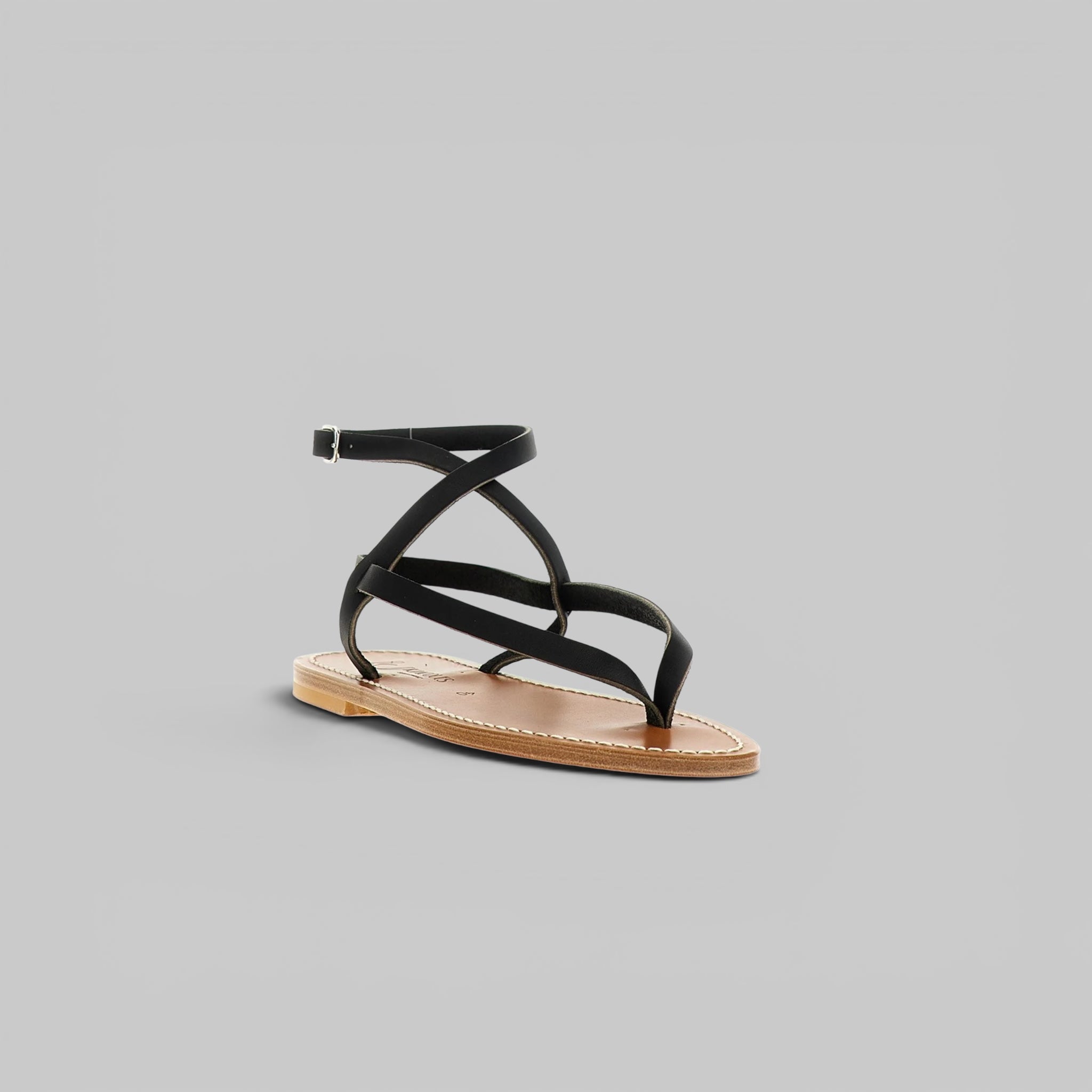 Black sandal with multiple straps on a gray background